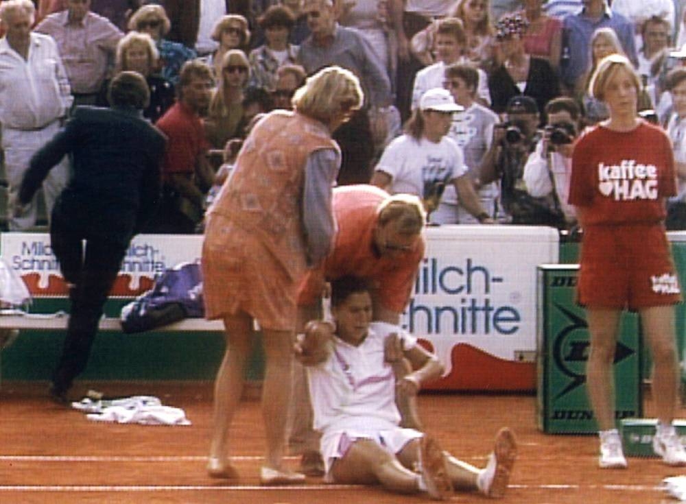 This handout TV-Grab released by German TV Public Broadcaster ARD/NDR shows medical doctors taking care of Serbo-Croatian tennis player Monica Seles, injured by a knife attack on April 30, 1993 on the Rothenbaum tennis court in Hamburg, northern Germany. - Thirty years have passed since a crazed Steffi Graf fan stabbed Monica Seles on court in Hamburg, but witnesses can still recall the attack in vivid detail. Several eye-witnesses who were on site at the time, from players to medical professionals, this week recalled the moment which shocked the world and derailed one of the most promising tennis careers in the history of the sport. - Pic: AFP