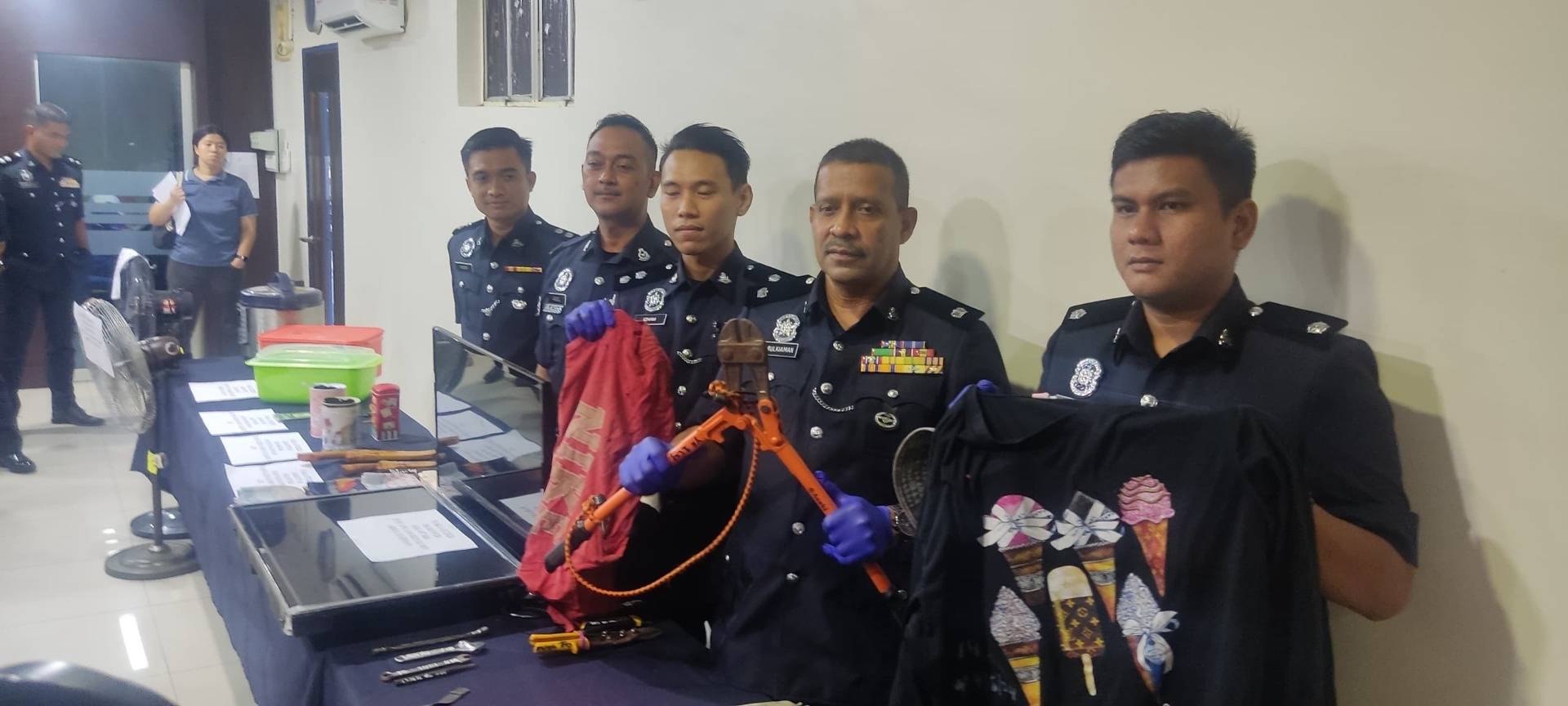 Mulkiaman (second, right) showing the item seized from the suspect.