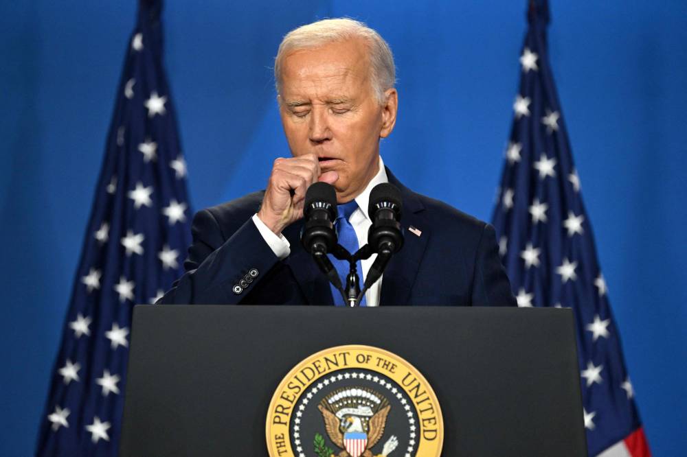 US President Joe Biden coughs as he speaks during a press conference at the close of the 75th NATO Summit at the Walter E. Washington Convention Center in Washington, DC on July 11, 2024. - Photo by AFP