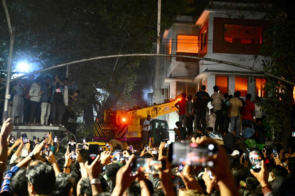 Protesters use a crane truck to demolish the Bangabandhu Memorial Museum, the former residence of Sheikh Mujibur Rahman father of the former Prime Minister Sheikh Hasina, as they storm the Museum, in Dhaka on February 5, 2025. (Photo by Munir Uz Zaman / AFP)
