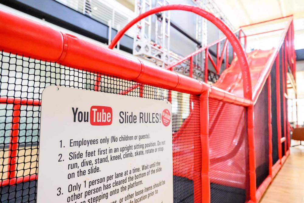 A slide that employees use to go down a floor is seen inside YouTube's corporate headquarters in San Bruno, California, on April 23, 2025. (Photo by JOSH EDELSON / AFP)